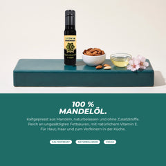 100 % Mandelöl: Flasche mit Mandeln, Mandelblüte und einer Schale Öl – kaltgepresst, naturbelassen, ohne Zusatzstoffe