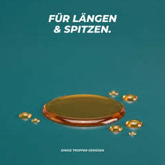 Goldene Öl-Pfütze mit kleinen Tropfen auf Petrol – für Längen und Spitzen, einige Tropfen genügen