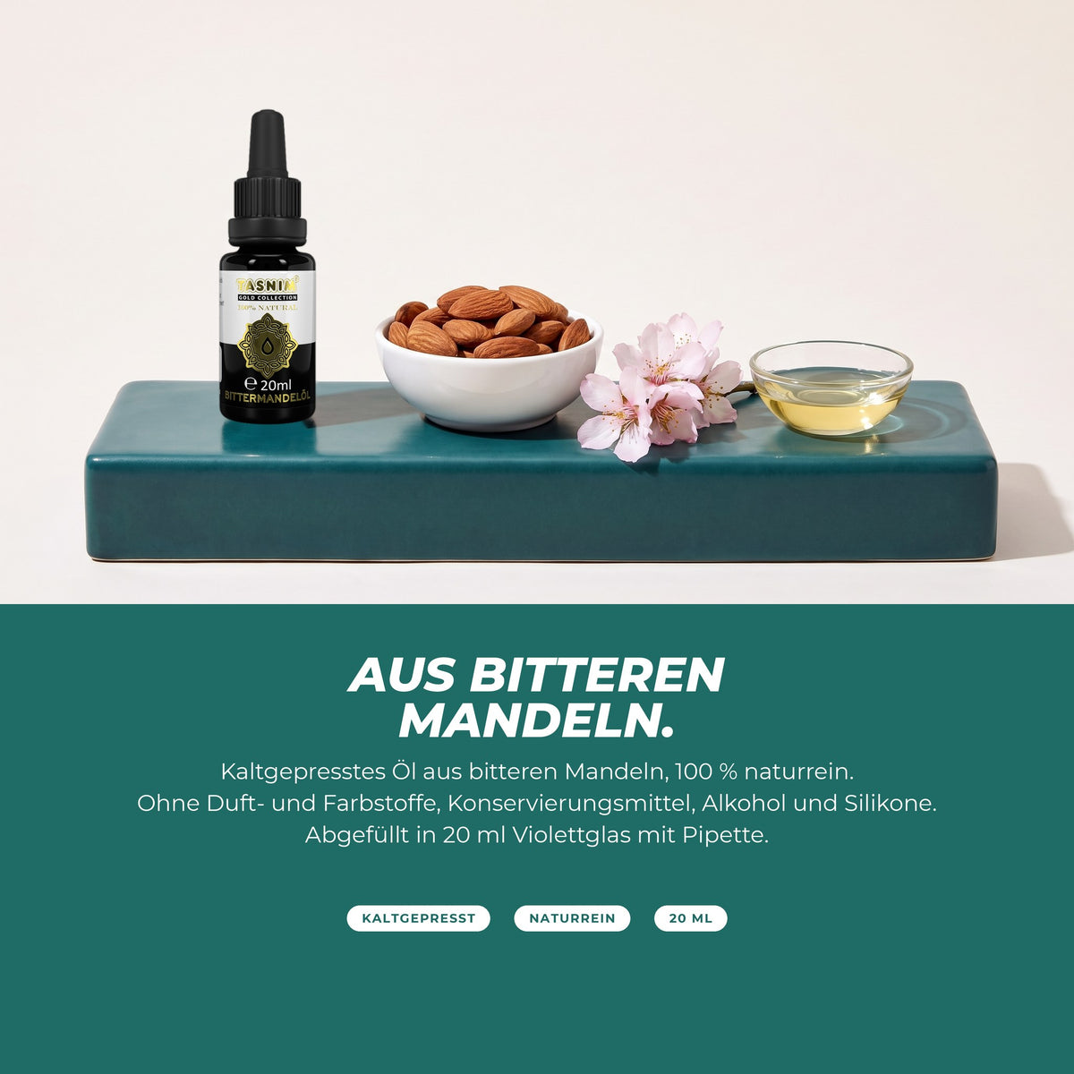 Aus bitteren Mandeln: Flasche mit Mandeln, Mandelblüte und einer Schale Öl – kaltgepresst, naturrein, ohne Zusätze