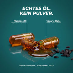 Echtes Öl, kein Pulver: geöffnete Kapsel mit flüssigem Schwarzkümmelöl, vegane HPMC-Hülle ohne Gelatine